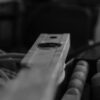 Black and white image of construction tools in a workshop, emphasizing a spirit level.