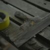 Close-up of a spatula and duct tape on an aged wooden surface. Perfect for DIY and renovation themes.