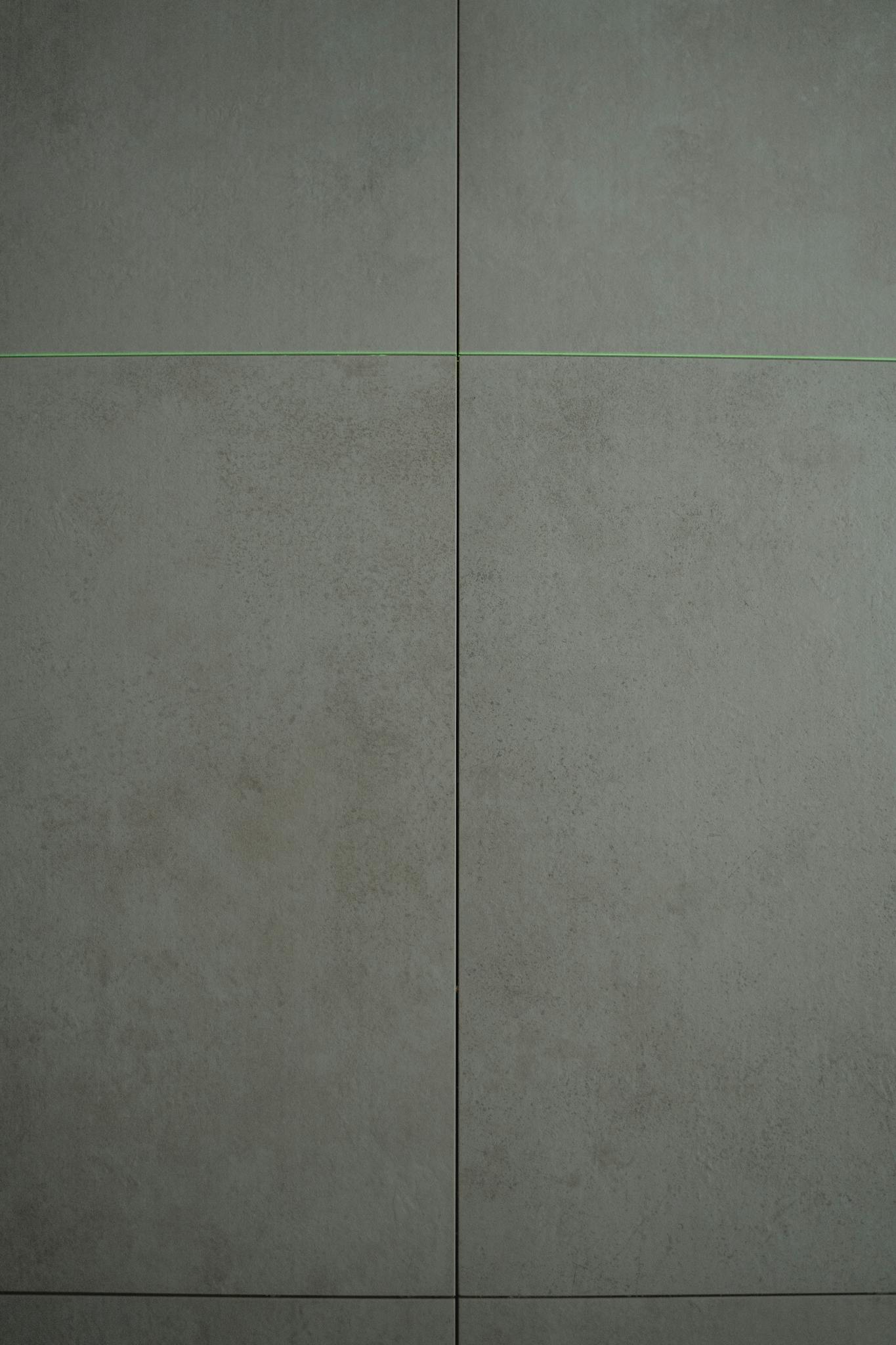Minimalist concrete wall texture with slight patterns, ideal for backgrounds or design projects.